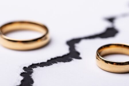 two gold rings on paper with black line drawn between them