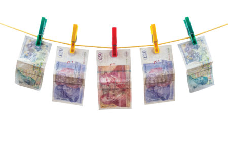 Washing line with bank notes drying on it