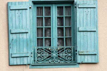 Understanding CGT on overseas property sales - Villa window with light blue wooden shutters