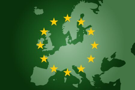 CARBON BORDER ADJUSTMENT MECHANISM: Image of a green world map with EU member states stars